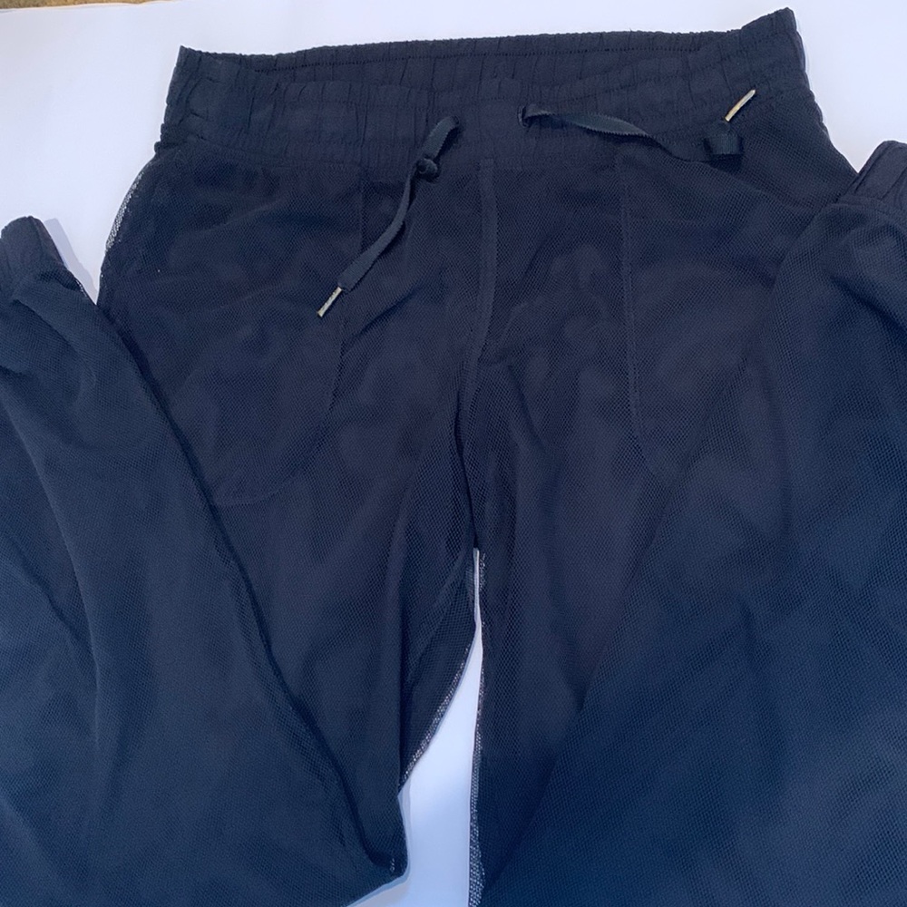Black Lululemon joggers pants with mesh top layer
